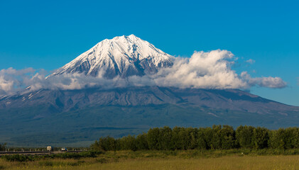 Fototapeta premium Panoramic view of a large volcano with a snowy peak