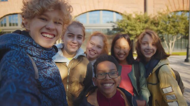 Group of multiethnic happy children taking selfie outdoors
