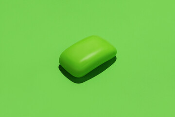 Green soap bar in center of green background