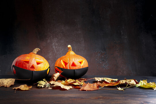Halloween. Image featuring two pumpkins with burning candles and lightning