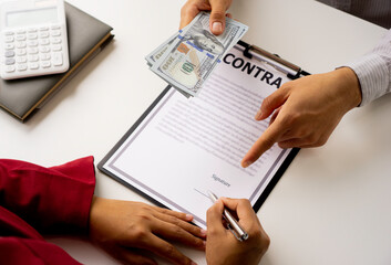 bribery and corruption concept, businessmen offer bribes to business women to sign and manage real estate contracts smoothly.