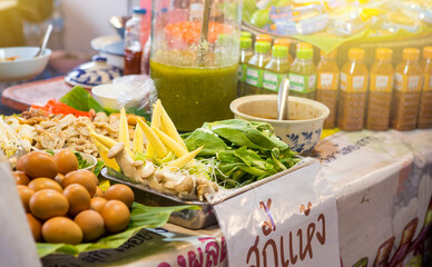 Thai Fresh food stall at the market in Thailand, Spicy Thai style salad and noodle soup with variety of vegetable and spicy sauce at the market
