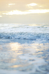 Ocean wave on a sandy beach in the morning