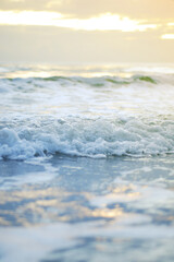 Fototapeta na wymiar Ocean wave on a sandy beach in the morning
