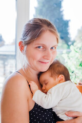 Happy mother holding newborn