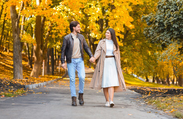 Fototapeta premium Beautiful picture of couple in love walking by autumn forest