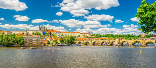 Fototapeta na wymiar Panorama of Prague city historical centre with Prague Castle, St. Vitus Cathedral in Hradcany district, Charles Bridge Karluv Most across Vltava river. Panoramic view of Prague city, Czech Republic