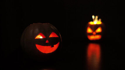 Young woman lights a candle in a pumpkin for Halloween. Preparation for the holiday. Sparkler.