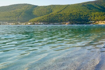 Crystal clear emerald sea waters, sandy bottom seen through, neat shades and colours of Aegean Sea. Beautiful pure nature shot