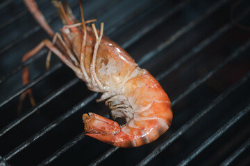 Grilled shrimps or prawns on the flaming grill