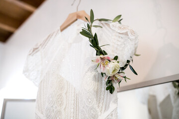 floral head wreath for bride hanging on wedding dress