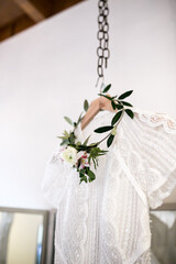 floral head wreath for bride hanging on wedding dress
