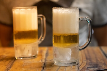 Jugs of beer placed on wooden bar