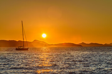 Boat sailing at sunset
