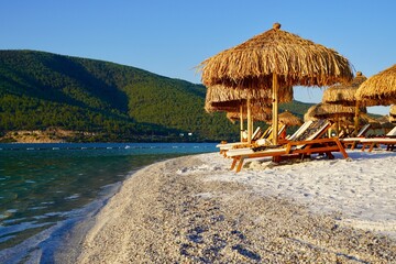 Bodrum, Turkey - August, 2020 tropical paradise beach with of Hotel Lujo with white sand and coco palms travel tourism wide panorama background concept with parasol. Luxury tourism conception