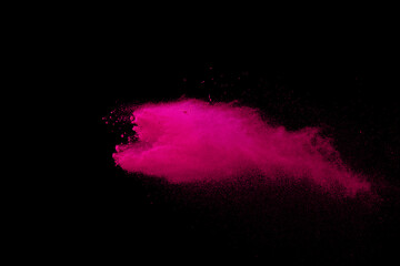 Pink powder explosion on black background. Colored cloud. Colorful dust explode. Paint Holi.