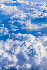 Naklejka na ściany i meble Clouds and sky as seen through window of an aircraft.