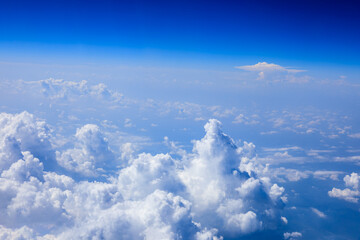 Clouds and sky as seen through window of an aircraft.