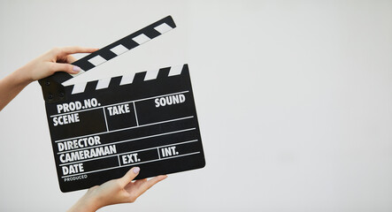 Black cinema clapper board in woman hands
