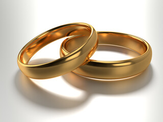 Wedding gold rings lie in each other isolated