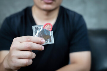 This man uses a condom on his girlfriend in a hotel.