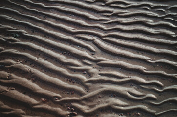 Obraz premium rippling sand under water.The texture of river sand from the waves.
