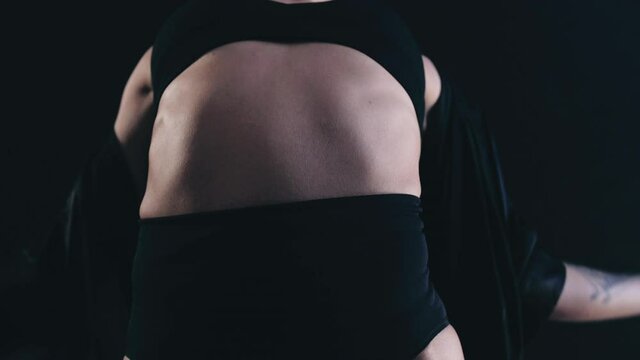 Female agile dancer against a black background dancing. High quality FullHD footage. 