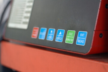 Digital diesel smoke tester at vehicle inspection station.
