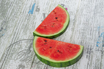 Fototapeta na wymiar closeup of some pieces of refreshing watermelon on a Gray background