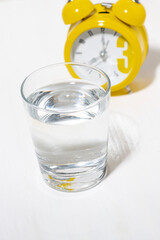morning glass of pure water, conceptual photo on white background, top view