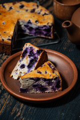 piece of blueberry pie on a clay plate, top view