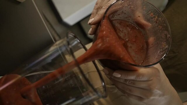 Pour fruit cocktail from the mixer bowl