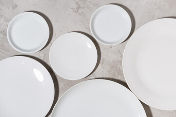 set of clean white plates on white background