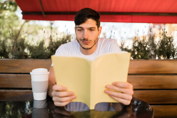 Man enjoying free time and reading a book.