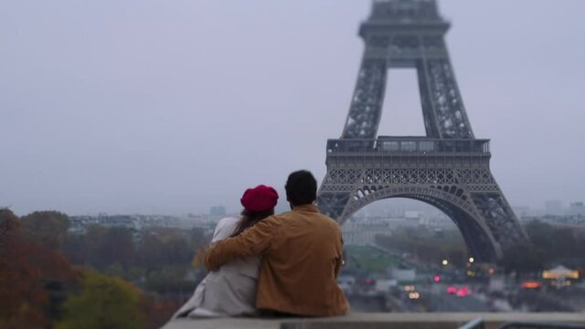 Couple admiring Eiffel tower in foggy weather