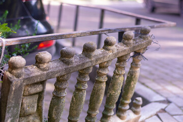 An old stone balustrade in need of repair and restoration. Dilapidated fence. Close-up, selective...