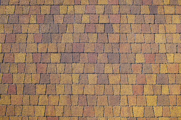 geometric pattern mosaic colored pavers. Decorative textured colored background from stonework.