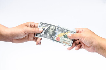 The U.S. dollars banknotes of the united States of America in the hand. The stack of money for the financial concept of earnings or business concept.