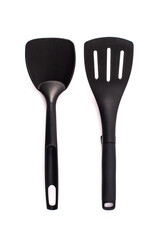 Black plastic kitchen spatula and spoon isolated on white background