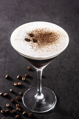 Martini espresso cocktail in glass on black background