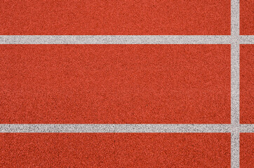 Fototapeta na wymiar Top view of the running track rubber lanes cover texture with white line marking for background.
