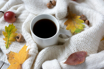 Obraz na płótnie Canvas A cup of hot coffee and colorful autumn leaves and much more, a cozy warm look. Hello, Autumn.