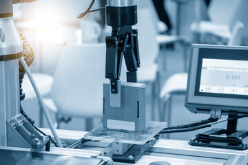The hi-technology  material handling process by robotic system. The automatic pneumatic robotic arm picking the container box in production line.