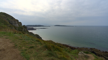 Brittany coast: cliff and clouds. View on the sea from trek trail. The cloudy sky is typical from autumn season in north Brittany.  
