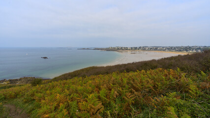 View on the beach from the trek trail. The cloudy sky is typical from autumn season in north Brittany. The tide is low.
