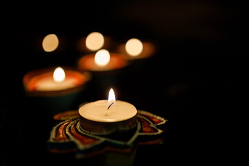 Fototapeta na wymiar Happy Diwali day. Colorful traditional oil lamp diya on dark background.