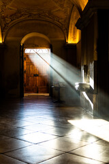 The entrance of the Herzogenburg abbey church of the Augustinian Canons in Lower Austria. Sunbeams highlighting the holy water basin. 