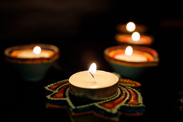 Happy Diwali day. Colorful traditional oil lamp diya on dark background.