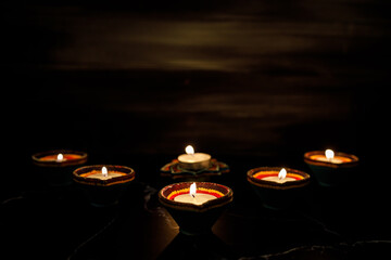 Happy Diwali day. Colorful traditional oil lamp diya on dark background.