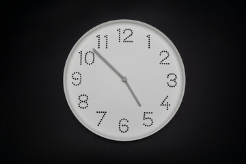 Minimal white clock Isolated showtime 04.53 o'clock on black background.